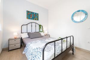 a bedroom with a bed and a mirror at Tarragona - 3BR - Beach - Nautical Port - Gastronomy in Tarragona