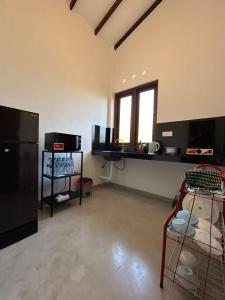 an empty room with a kitchen with a large window at Green Corridor - Ahangama in Ahangama