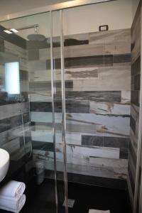 a bathroom with a shower with a glass door at Residenza RoMa in Tropea