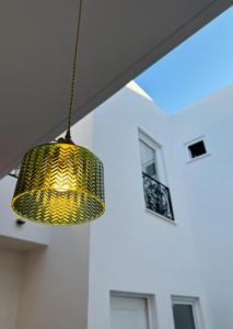 a yellow lamp hanging from a ceiling in a room at Hospedería Nieves Centro in Chipiona