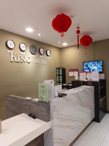 a kino hotel store with clocks on the wall at Kino Hotel in Shah Alam