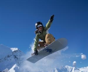 a person jumping in the air on a snowboard at Ferienwohnung im Chalet Alpenrose in Adelboden