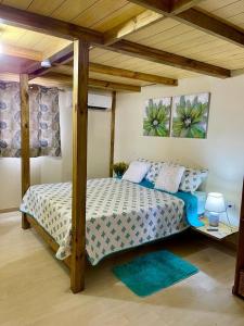 a bedroom with a bed with a wooden canopy at Casa Mano Juan in Mano Juan