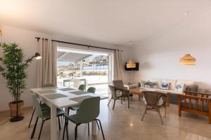 a dining room and living room with a table and chairs at Calala House with huge terrace in Candelaria