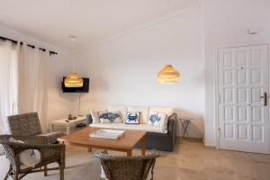 a living room with a couch and a table at Calala House with huge terrace in Candelaria