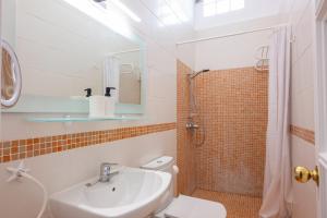 a bathroom with a sink and a toilet and a shower at Calala House with huge terrace in Candelaria +17 photos