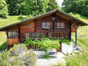 a log cabin in a field with trees at Meieli's Chalet in Hofstetten