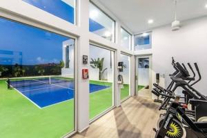 a gym with a tennis court inside of a house at Oceanside 2 Bedroom Luxury Villa with Private Pool, 500ft from Long Bay Beach -V3 in Providenciales