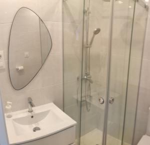a bathroom with a shower and a sink and a mirror at Casa de Ángeles in Fisterra