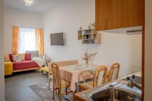 a kitchen and living room with a table and a couch at Hirschenwirt in Schönbühel an der Donau