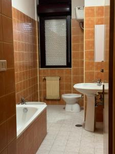 a bathroom with a tub and a toilet and a sink at Volturno House2 in Rome