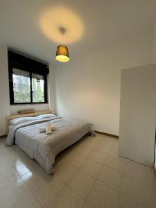 a bedroom with a large bed with a large window at Volturno House2 in Rome