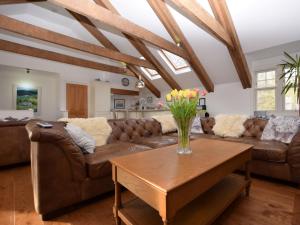 a living room with a couch and a table at 5 bed in Colintraive 74117 in Colintraive