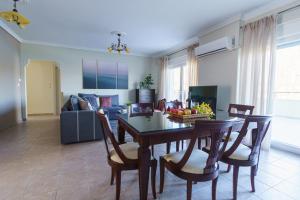 a dining room and living room with a table and chairs at view kastoria in Kastoria