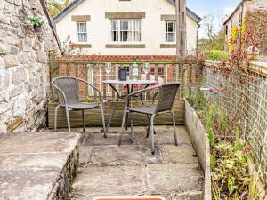 a patio with two chairs and a table at 1 Bed in Hognaston PK927 in Hognaston