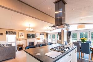 a kitchen and living room with a stove top oven at Lakeside Gem with Hot Tub in York