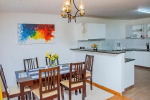 a kitchen and dining room with a table and chairs at Casa Misa Riverside Duplex in Nairobi