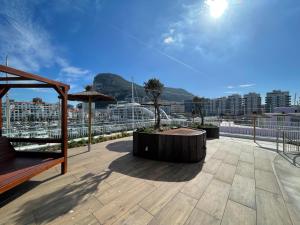 a rooftop patio with a view of a city at Deluxe Marina View Seafront Gibraltar Stay in Gibraltar