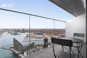 a balcony with a table and a view of the city at Penthouse paradise on 39th floor in Aarhus