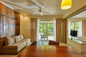 a living room with a couch and a ceiling fan at Bahia Principe Luxury Sian Ka´an - Adults Only - All Inclusive in Akumal