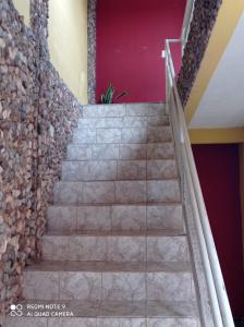 a set of stairs in a building with a stone wall at Apartamento Aconchegante 4 in Rondonópolis