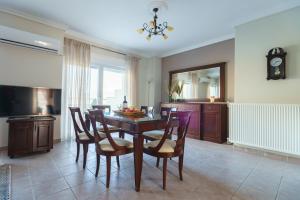 a kitchen and dining room with a table and chairs at view kastoria in Kastoria