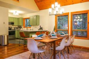 a dining room with a wooden table and chairs at Fern Hollow in Glacier