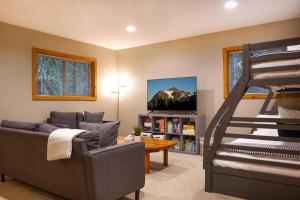 a living room with a couch and a bunk bed at Fern Hollow in Glacier