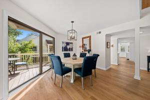a dining room with a table and chairs and a balcony at 770 Spinnaker Beach House in Seabrook Island
