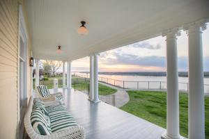 a porch with chairs and a view of the water at Clifton House - Big River South - Mississippi River Views, Queen Suite in Natchez