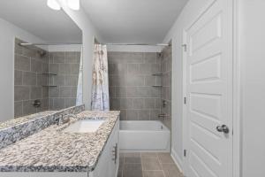 a bathroom with a sink and a tub and a shower at The Arches in Lawrenceville +36 photos