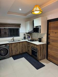 a kitchen with a sink and a stove top oven at Sambest Homes in Lagos