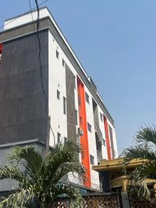 a building with an orange stripe on the side of it at Sambest Homes in Lagos