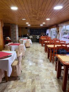 a dining room with tables and wooden tables and chairs at Hotel Yagan Porvenir in Porvenir