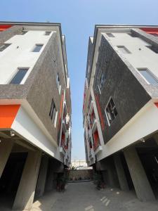 two buildings next to each other on a street at Sambest Homes in Lagos