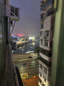 a view from a window of a building and a street at Sleep Cubee Hostel in Hong Kong