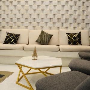 a living room with a white couch and a coffee table at KW HOTEL in Uyuni