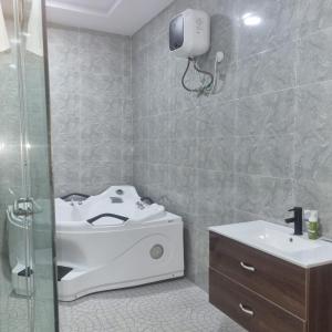 a bathroom with a sink and a toilet and a shower at The Residenze Adeniyi Jone Ikeja in Lagos