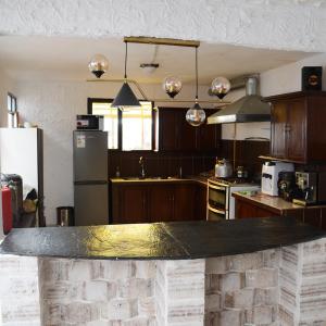 a kitchen with a black counter top in a room at KW HOTEL in Uyuni