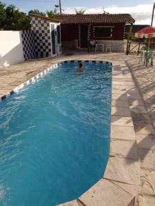 a large blue swimming pool in front of a house at Vila Harmonia in Conde