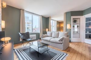 a living room with a couch and a table at Charming 2 bedroom apartment - Old Lille in Lille