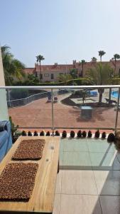 a balcony with a table and a view of a park at Sunny Suite in San Miguel de Abona