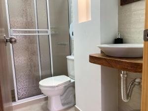 a bathroom with a toilet and a sink at Casa Lubel in Salento