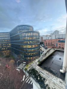 a view of a tall building with a bridge at 2 pièces duplex Issy Les Moulineaux in Issy-les-Moulineaux