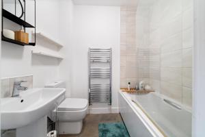 a bathroom with a sink and a toilet and a tub at 7Nights Special l Modern House near City Center Sleeps 6 with Free Parking l By Zen Nights Short Lets & Serviced Accommodations in Leicester +23 photos