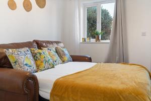 a bedroom with a bed and a couch and a window at 7Nights Special l Modern House near City Center Sleeps 6 with Free Parking l By Zen Nights Short Lets & Serviced Accommodations in Leicester