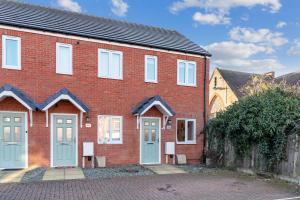 a red brick house with blue doors and windows at 7Nights Special l Modern House near City Center Sleeps 6 with Free Parking l By Zen Nights Short Lets & Serviced Accommodations in Leicester