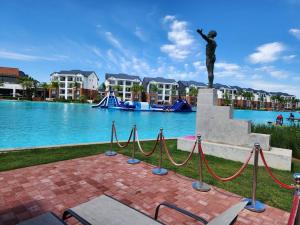 a statue in front of a large pool with houses at 297 The Blyde Crystal Lagoon in Pretoria