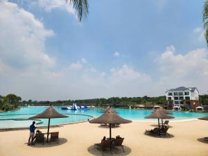 a beach with chairs and umbrellas in front of a pool at 297 The Blyde Crystal Lagoon in Pretoria +19 photos