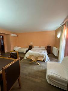 een hotelkamer met 2 bedden en een bank bij I Campanili in Agrigento